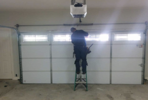 Worker Installing Garage Door